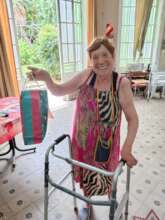 Mrs. A smiling with her present