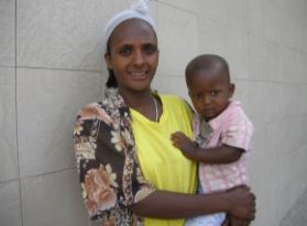 Jawar trying to hide in his mom's arm