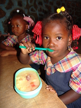 A young Haitian girl enjoys a WFP meal