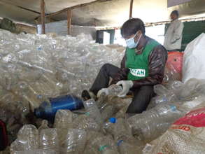 Wastepickers Shredding Plastic Waste