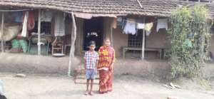 Ritwik* with his mother before their hut