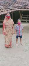 Abir with his mother in front of their house