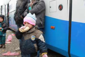 Refugee kid with the sandwich.