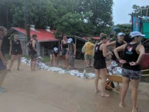 Volunteers building sandbag barrier