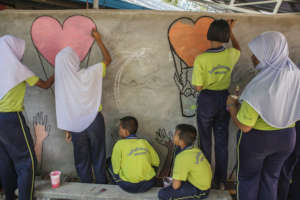 Thai Students Painting Wall Mural at Kitty City