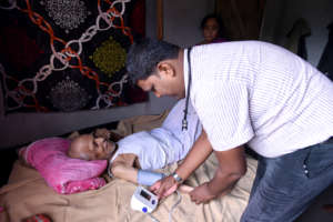 Dr. Mishra Tending to a Patient
