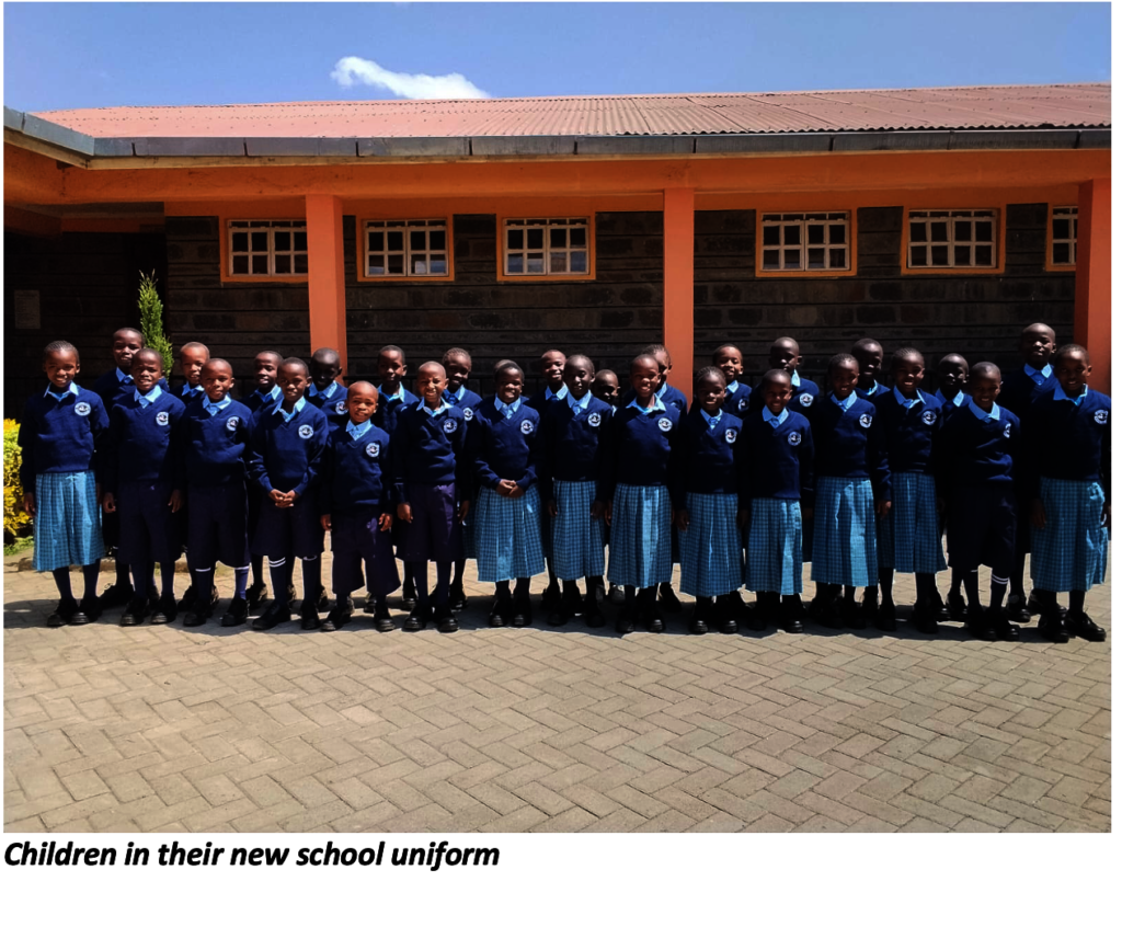 Children standing proud in new uniforms