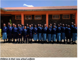 Children standing proud in new uniforms