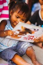 This girl is delighted to find books in Burmese