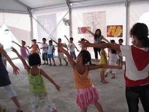 Children dancing in Half the Sky's BigTop in Sichuan