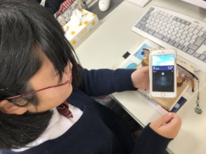A student checks the partner school's weather
