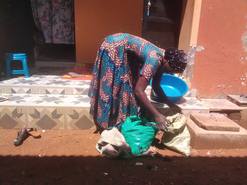 A widow receiving food items, project office