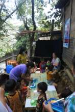 Some kids are gathered in a nearby outdoor space