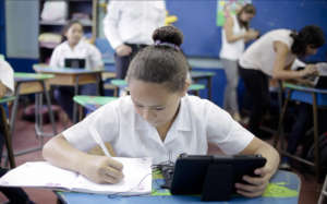 Girl using Duolingo on a donated tablet