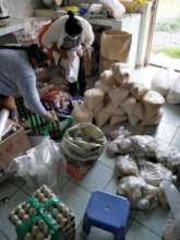 Luz and our kitchen staff prepare food packages