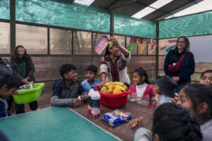 The children having fun preparing a fruit salad