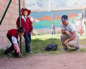 Teacher Angel playing marbles with the kids