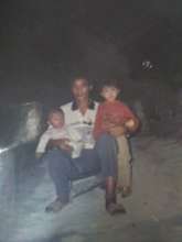QQ (right) with her father and younger brother