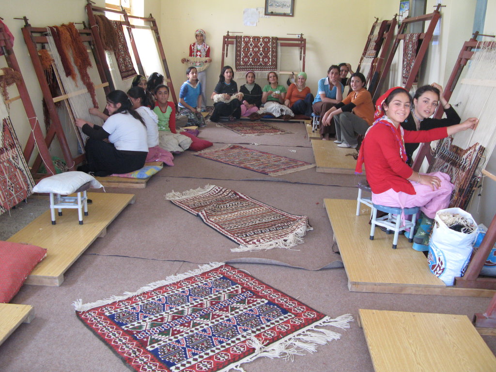 Girls weaving carpet