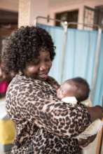 Dr. Pasquine Oygunsanya with an HIV-free baby