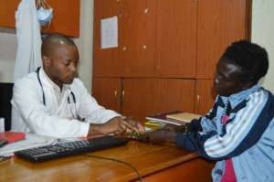 Linda receives medication from a clinical officer