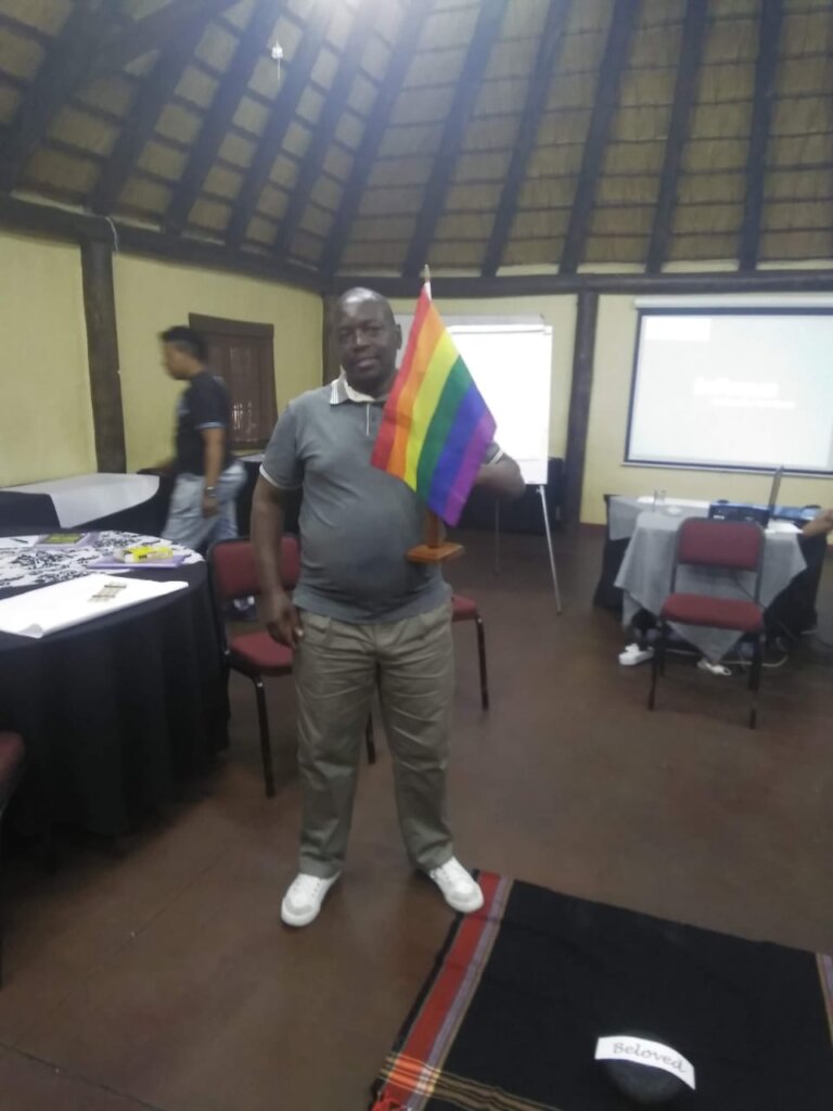 James holding a pride flag