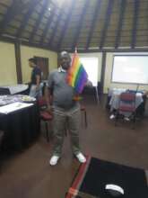 James holding a pride flag