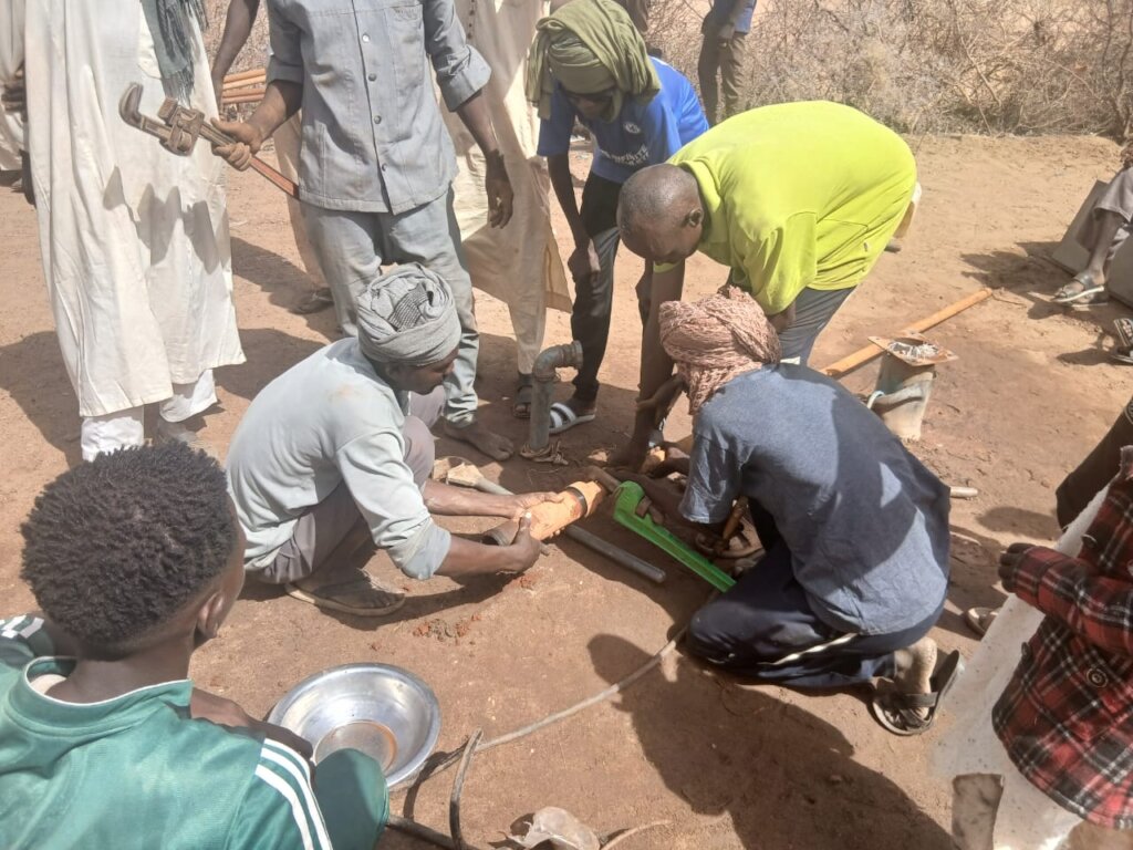 Handpump being repaired in Gawir Village