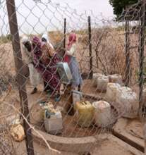 Jerrycans are lined up to collect clean water