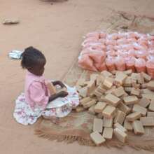 Little Girl Looking at the Soap for her Village