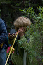 A volunteer takes measurements in the field