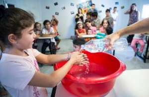 Children learning to wash their hands