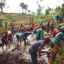 Villagers help dig into the source of the spring