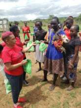 Women & girls receiving washable sanitary kits.