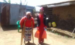 One of our students helping an elderly lady w/food