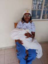 A student carrying the newborn of the alumni