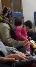 Ahmad plays while Reem and baby Lama look on