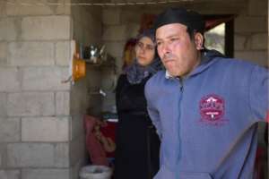 Hamza* stands in his improved home