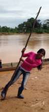 Aracely polling the river in Bolivian Amazon
