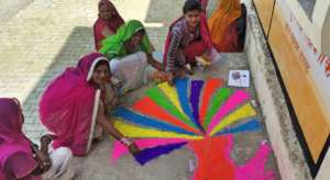 Women Making Colorful Rangoli
