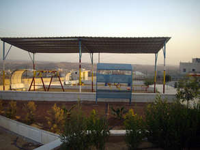 View of playground and village in the background