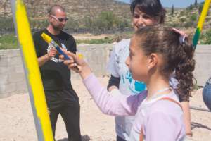 Both children and adults helping paint