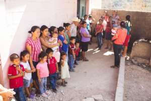 Villagers line-up, waiting to be tested