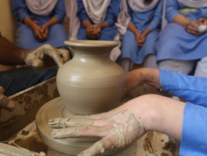 Students at the wheel during pottery club