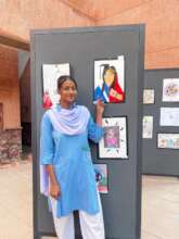 Student with her artwork at the Art Competition
