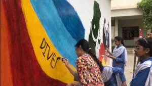students painting mural at SMB school