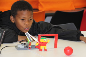 Denzil with the Lego robot he built and programmed