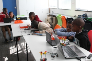 Children busy building and programming robots