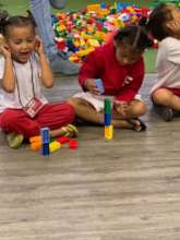 Zoe and a friend doing an activity with LEGO