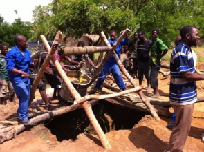 Example of builders digging a well
